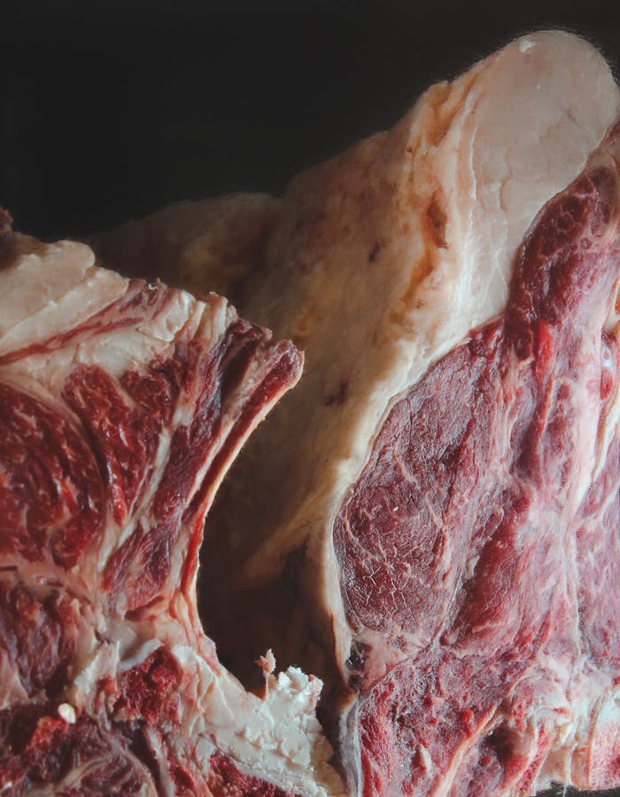 Detailed view of raw beef showcasing marbling and texture, ready for culinary use.